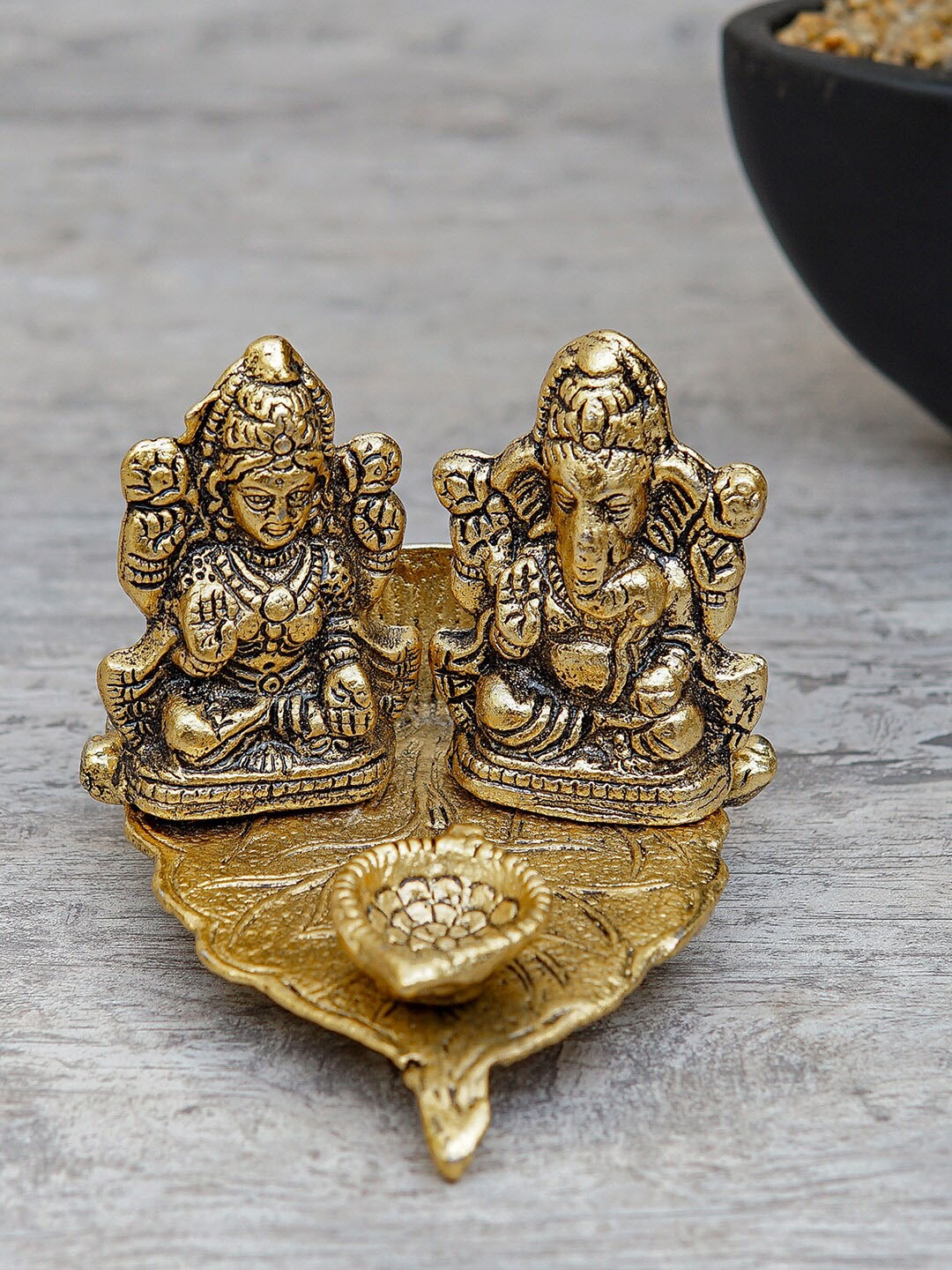 

StatueStudio Oxidized Gold-Toned Ganesha Lakshmi Leaf Diya Showpiece