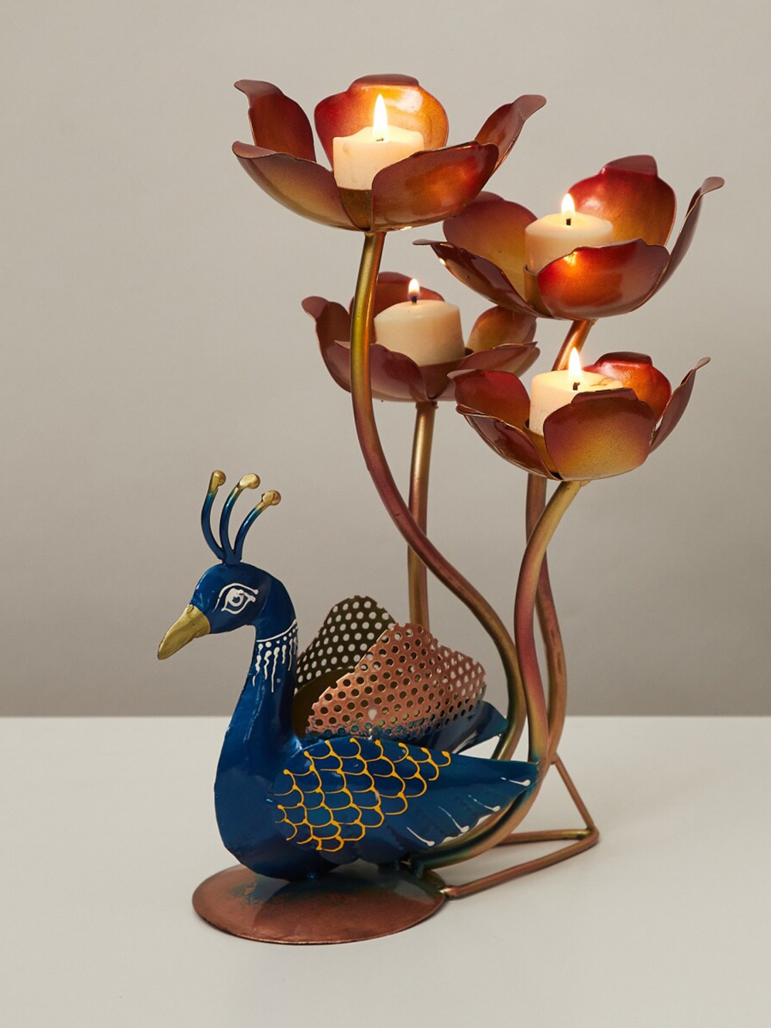 

Home Centre Blue & Brown Printed Peacock & Lotus T-lite Holder Showpieces