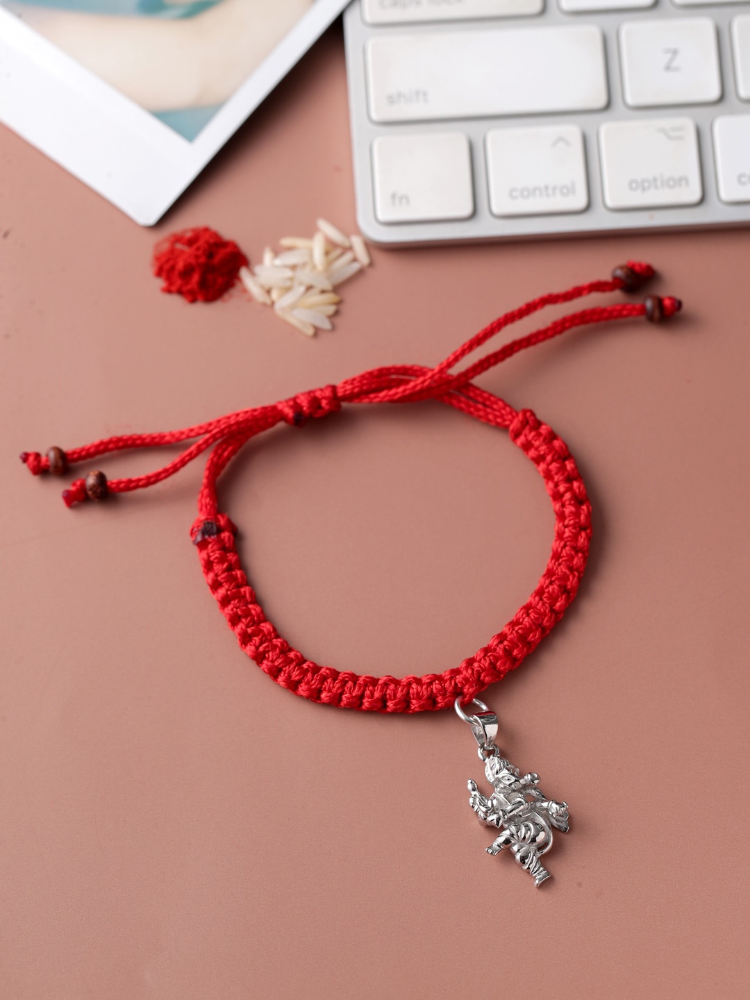 

ADORN by Nikita Ladiwala Unisex Silver-Toned & Red Rakhi