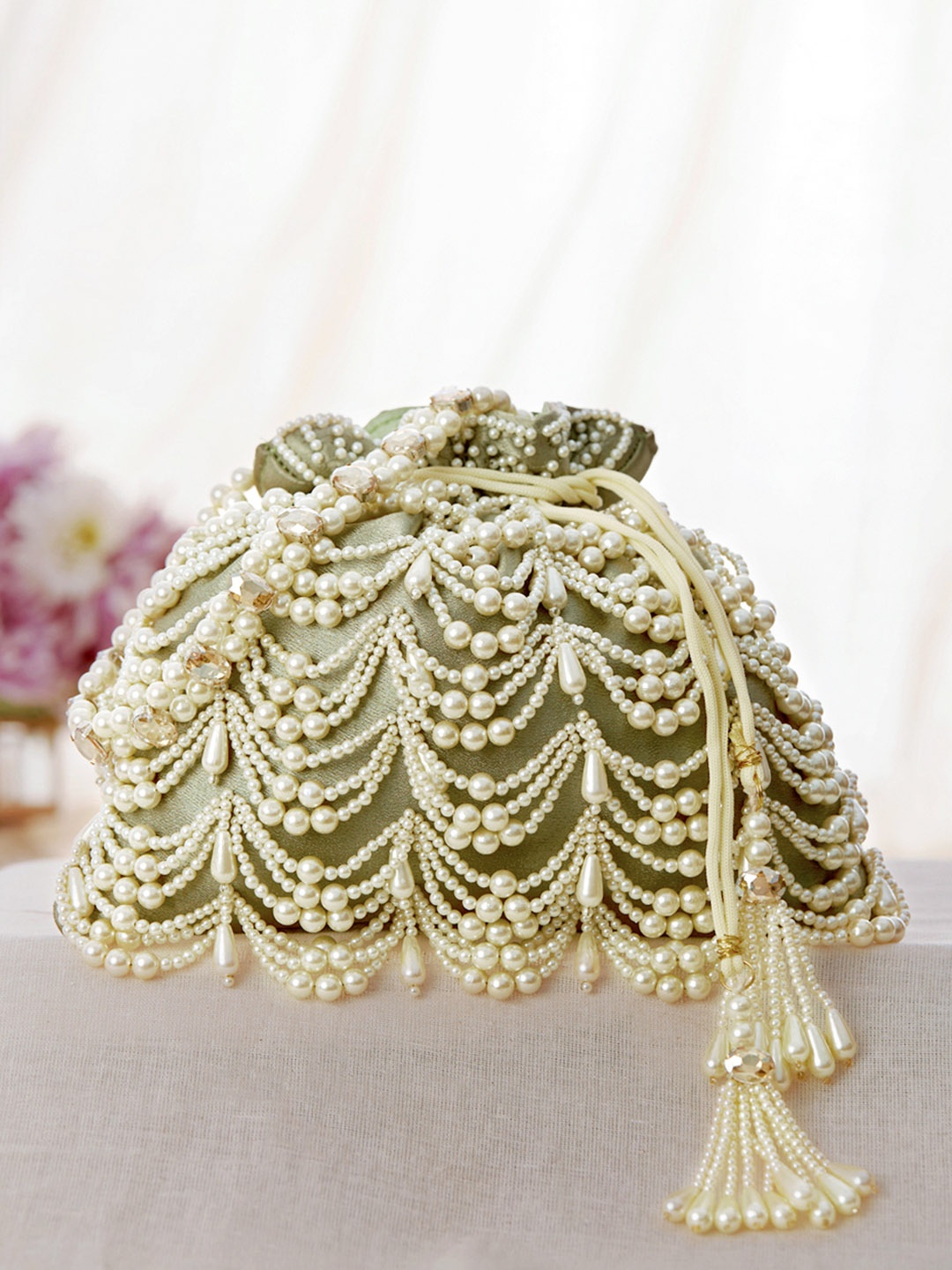 

Rubans Green & White Coloured Potli Bag With Embroided Design Of Pearls.