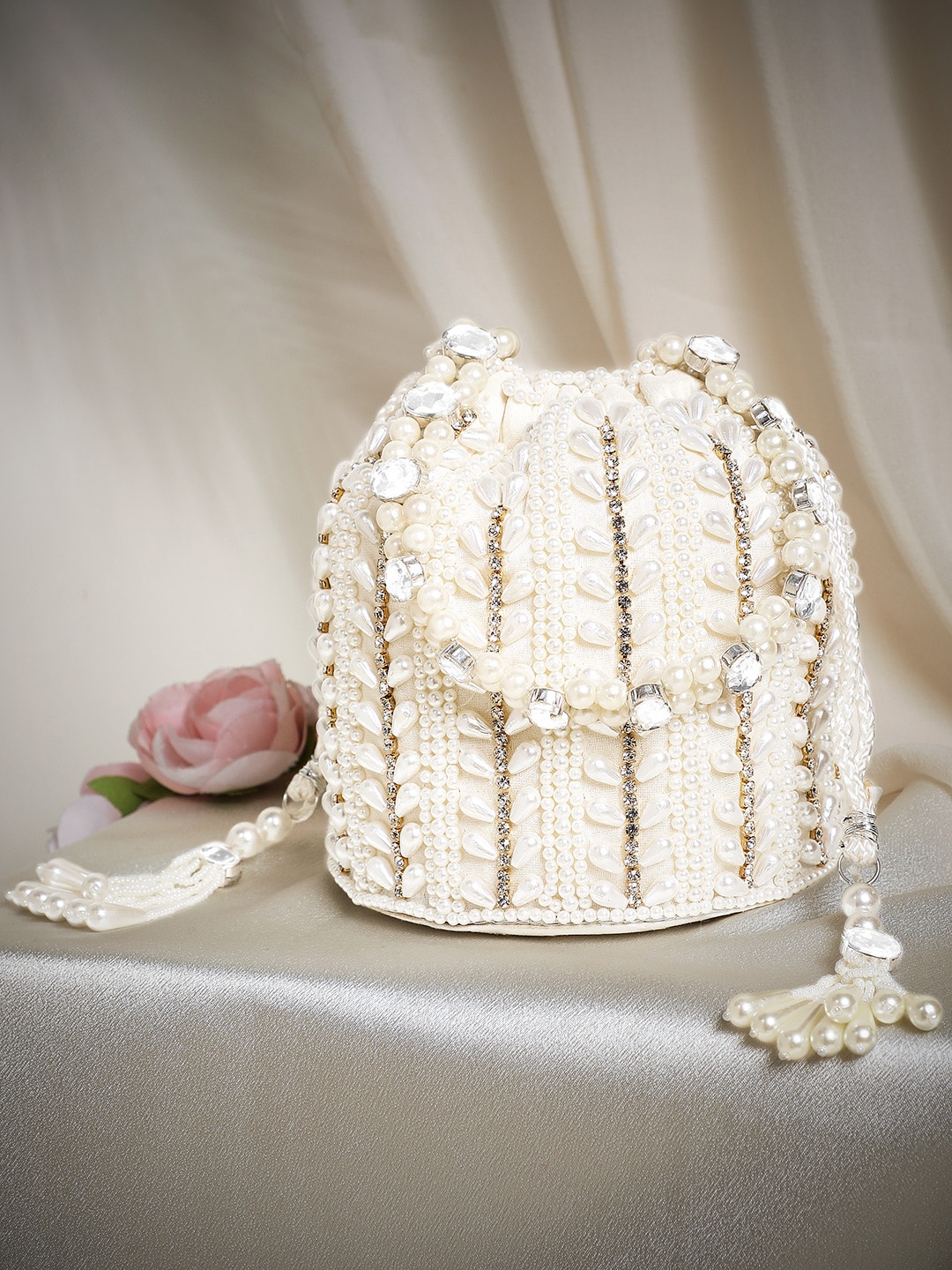 

Rubans Off White Coloured Potli Bag With Golden Embroided Design And Pearls.