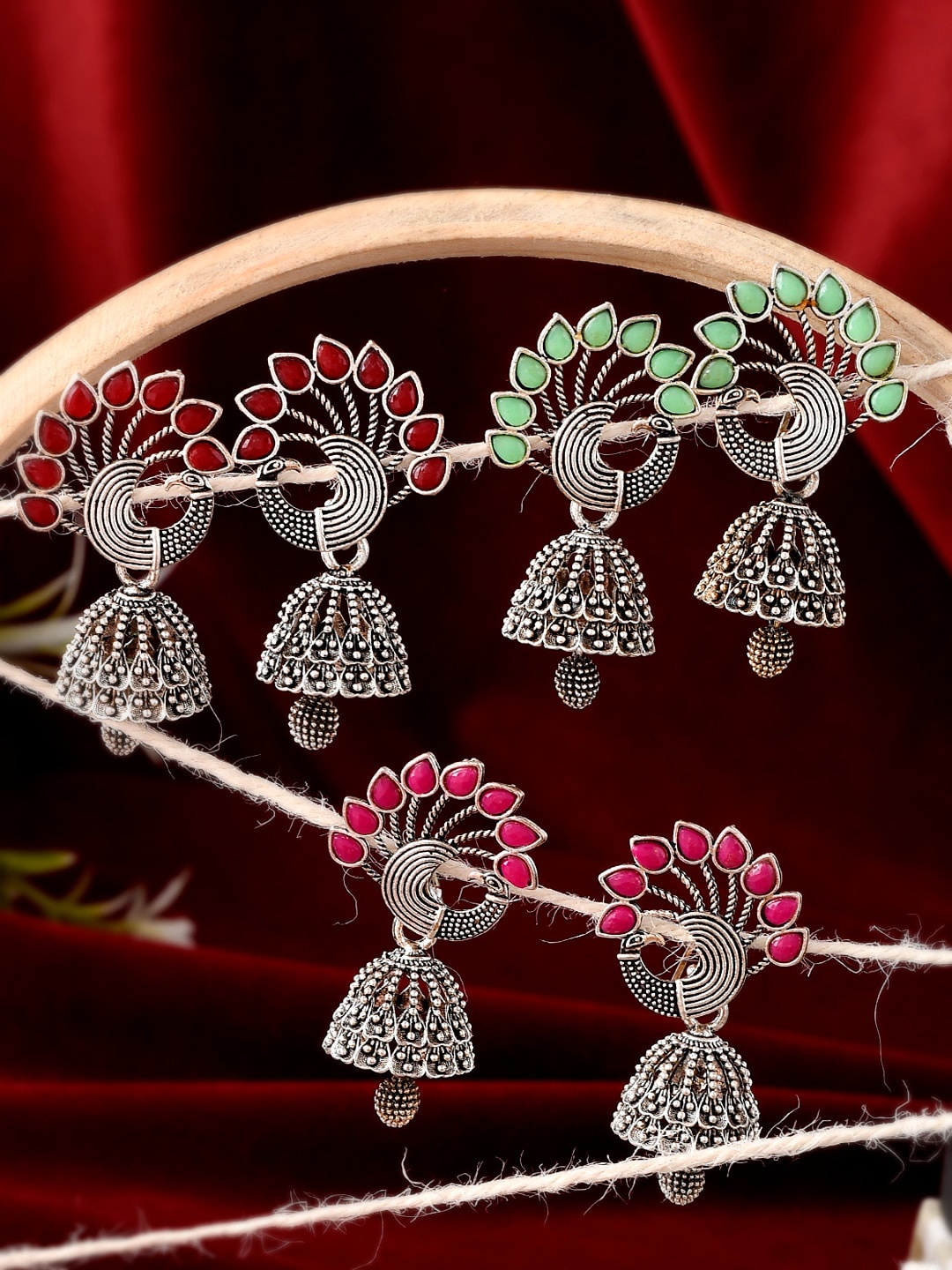 

Silvermerc Designs Silver-Toned & Pink Peacock Shaped Jhumkas Earrings
