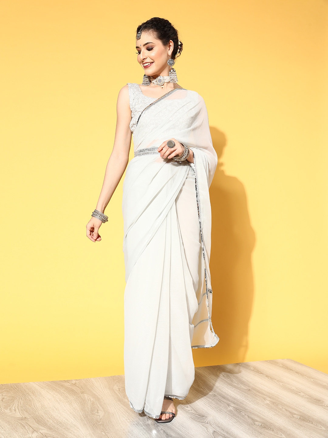 

Mitera Grey Solid Embellished Saree