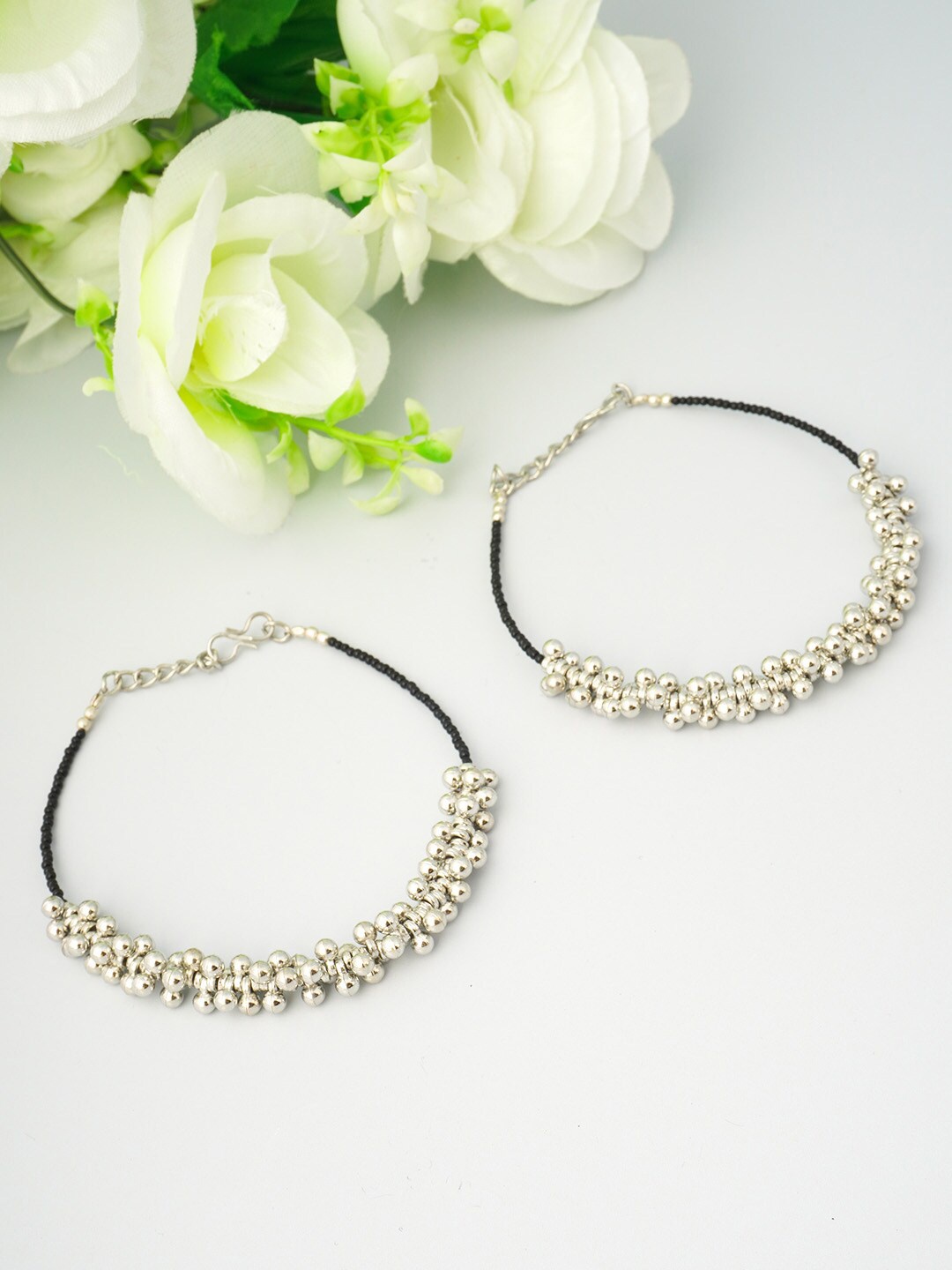 

Urmika Women Oxidised Set of 2 Black & Silver Ghungroo Beaded Anklet