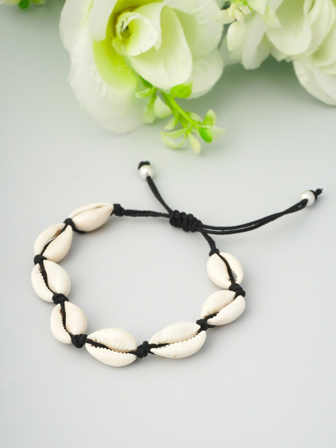 

Urmika Women Black & White Sea Shell Thread Anklet