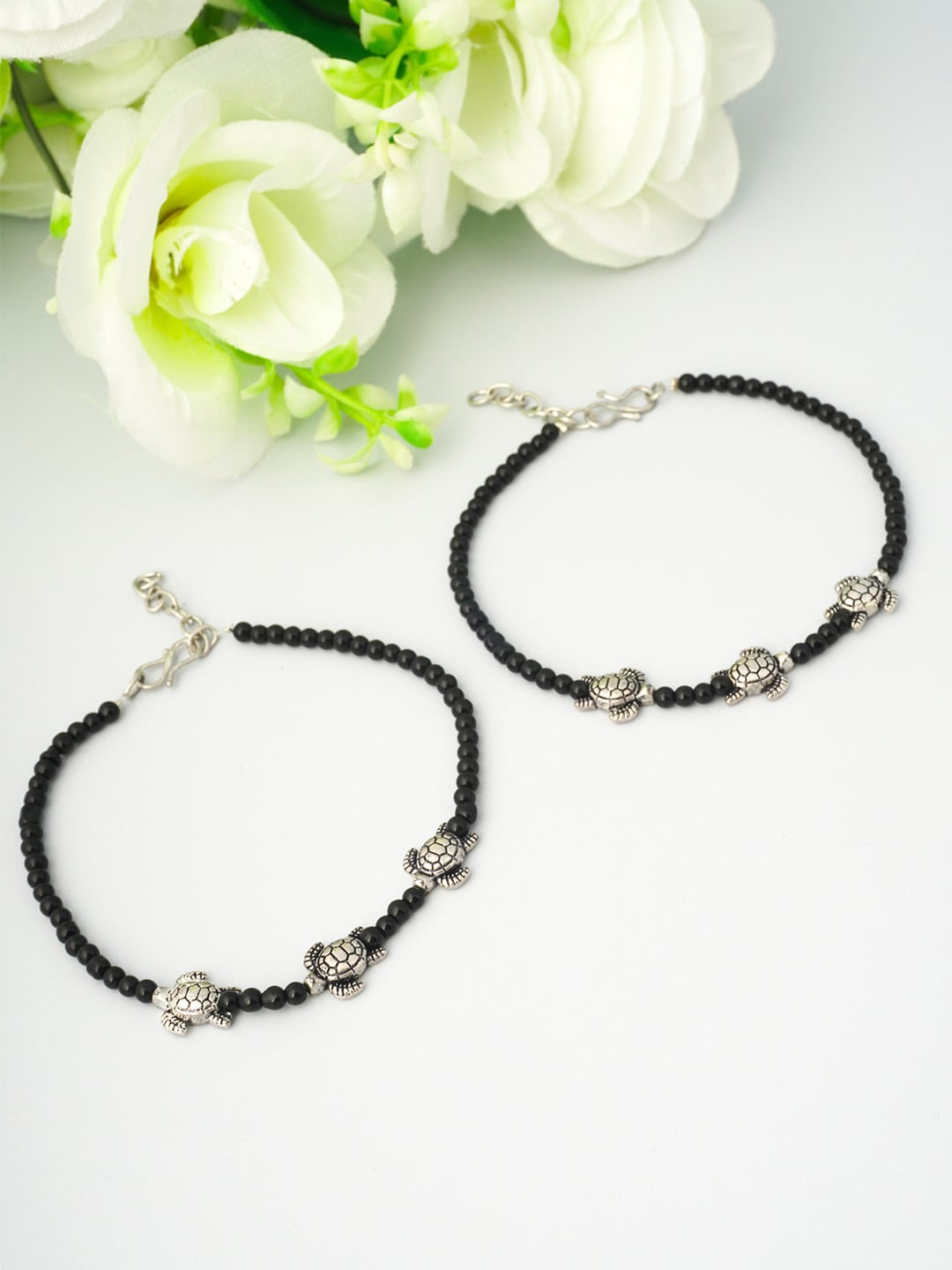 

Urmika Women Oxidised Black & Silver Turtle Beaded Anklet