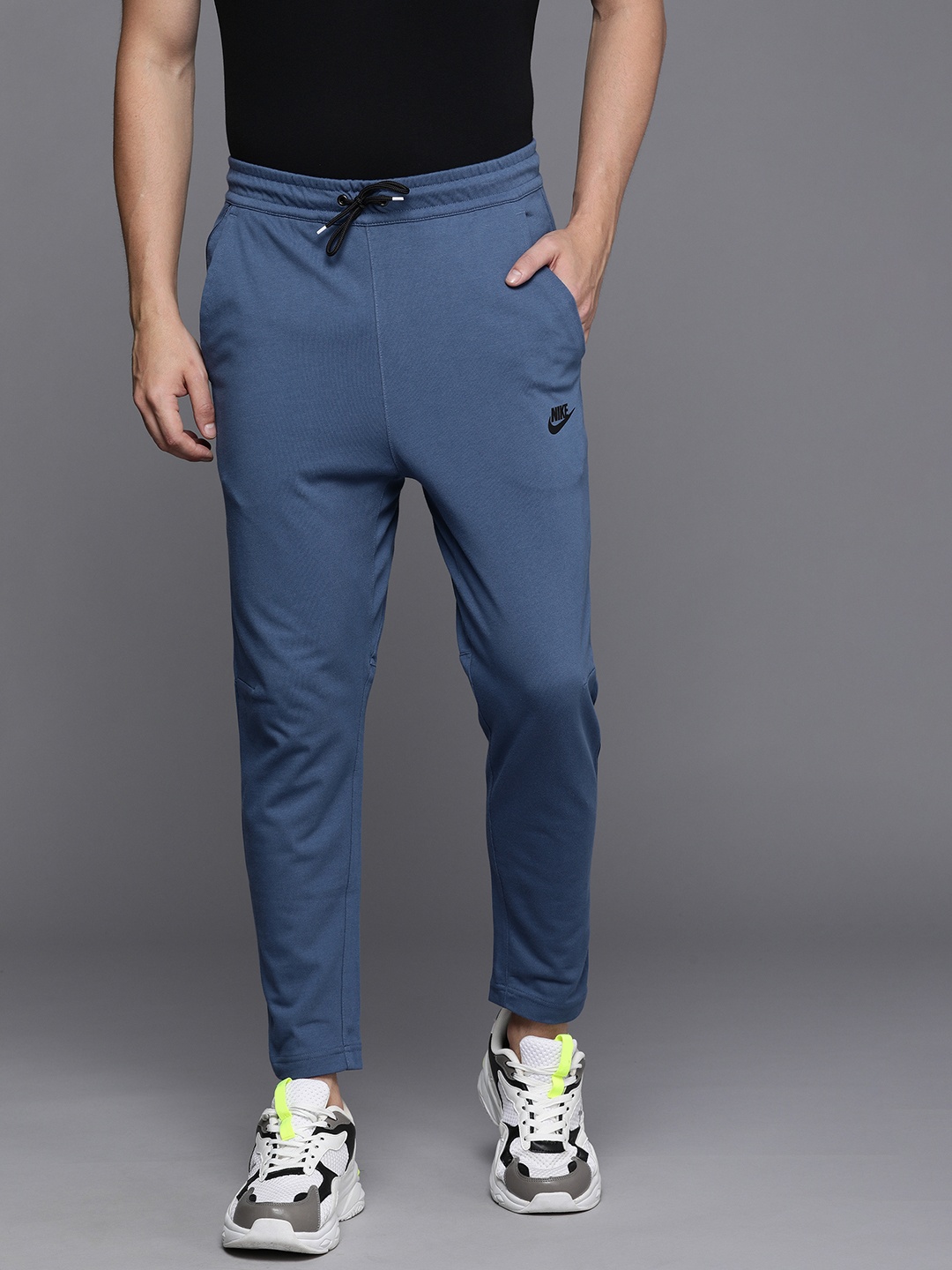 

Nike Men Blue Brand Logo Print Mid Rise Dry Fit Regular Track Pants