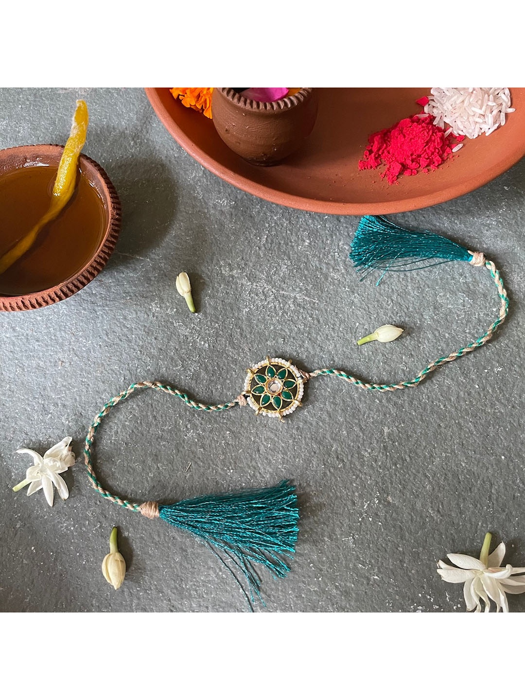 

Mitali Jain Gold-Toned & Blue Kundan Rakhi