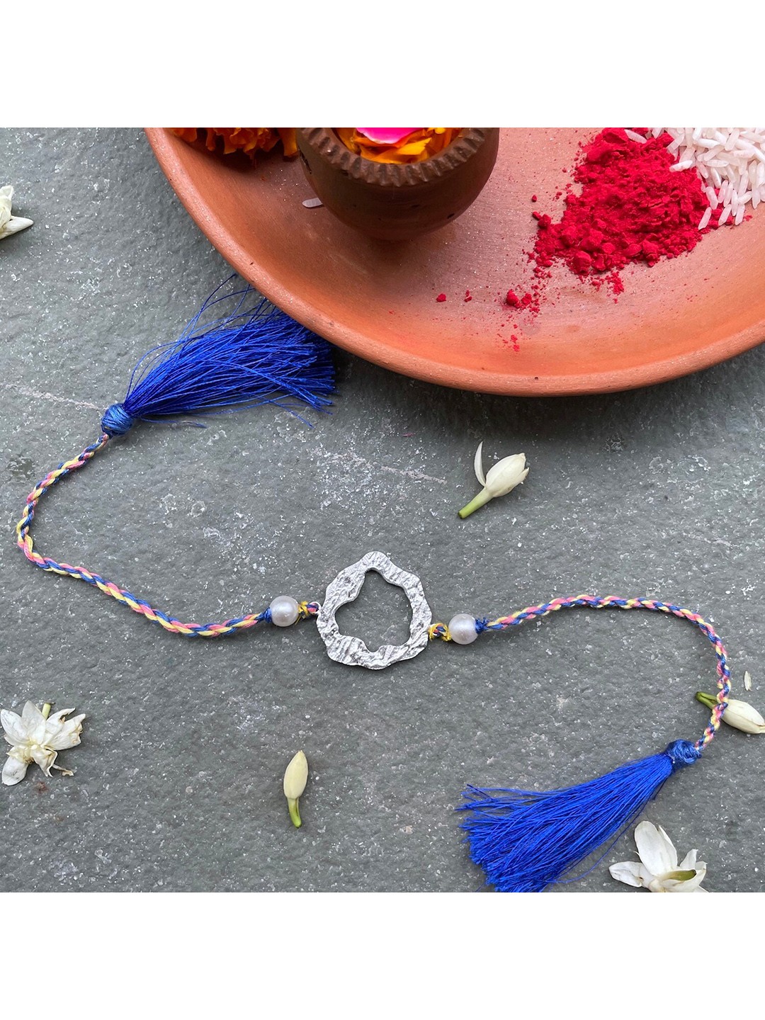 

Mitali Jain Blue & Pink Stering Silver Cilla Rakhi
