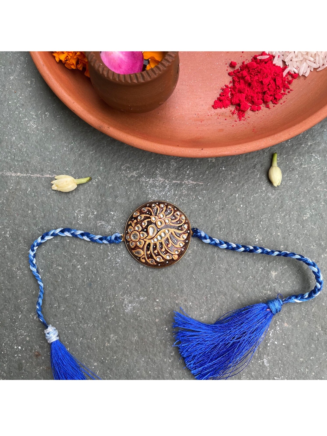 

Mitali Jain Brown And Blue Kundan Rakhi