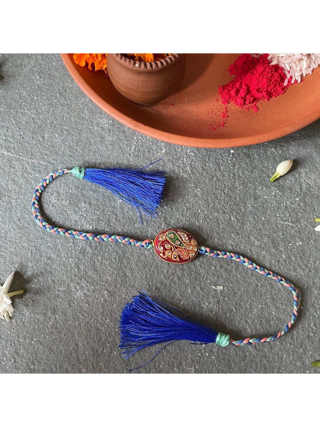 

Mitali Jain Orange and Blue Tanjore Rakhi