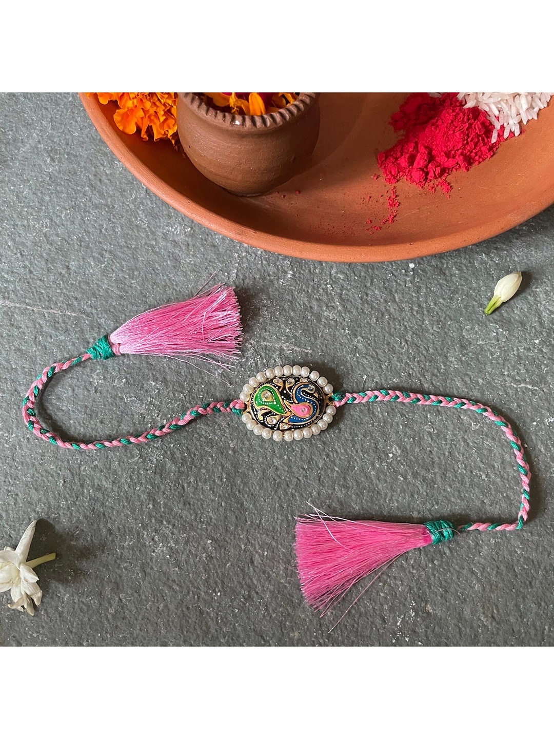 

Mitali Jain Green and Pink Tanjore Pearl Rakhi