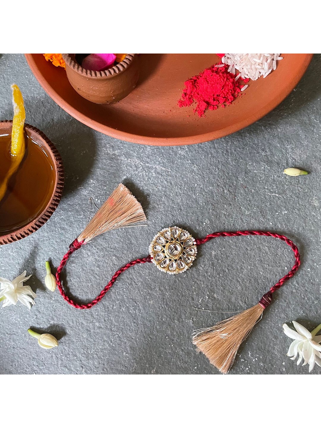 

Mitali Jain Gold-Toned & Cream-Colored Kundan Rakhi