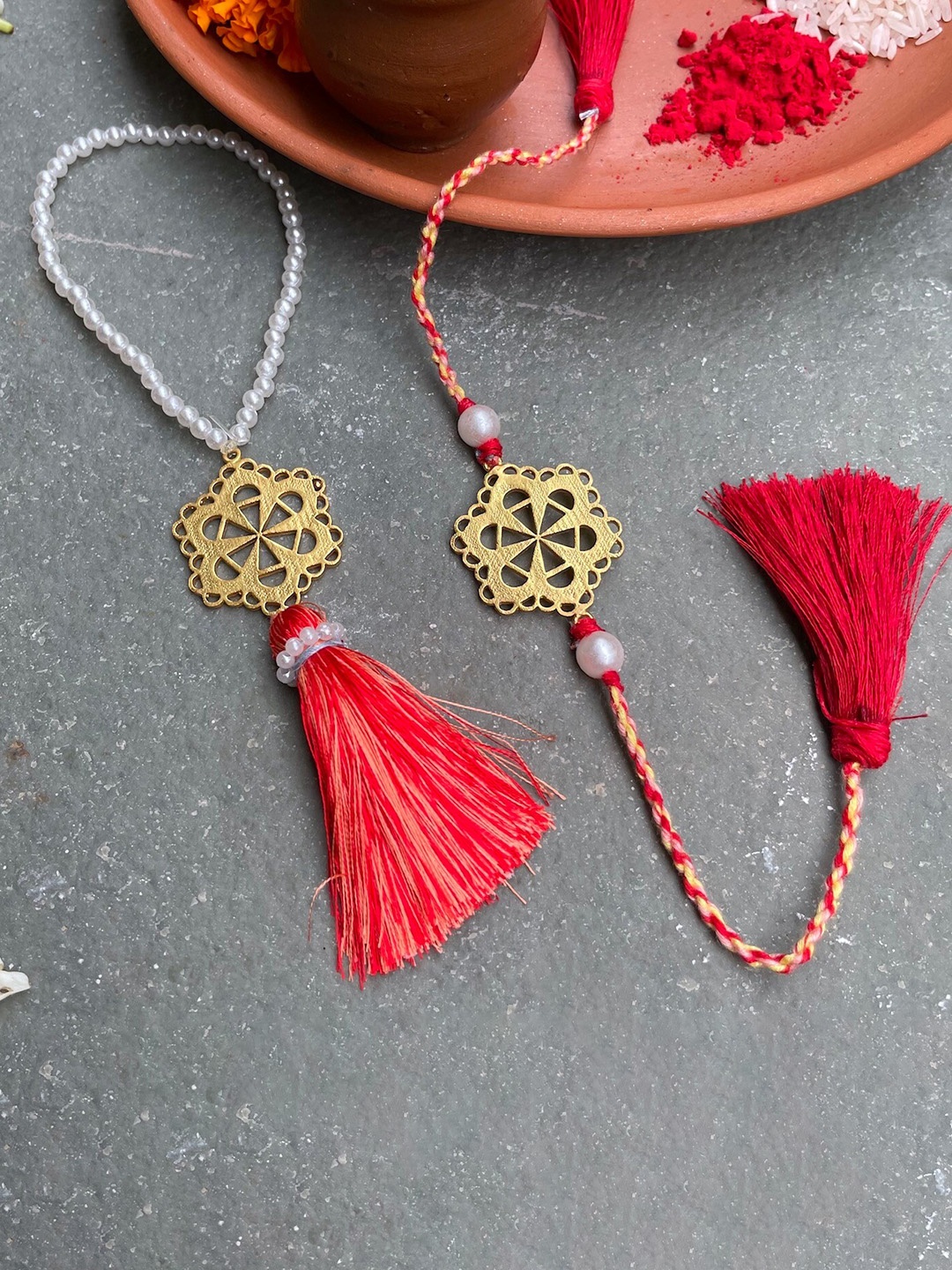 

Mitali Jain 2 Pieces Gold Toned & Red Mumtaz Rakhi and Lumba Set