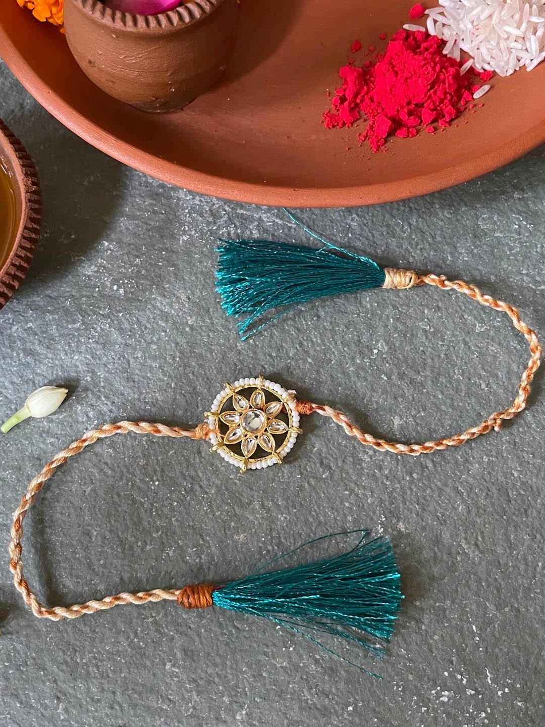 

Mitali Jain Gold & Green Kundan Rakhi Comes with roli and chawal