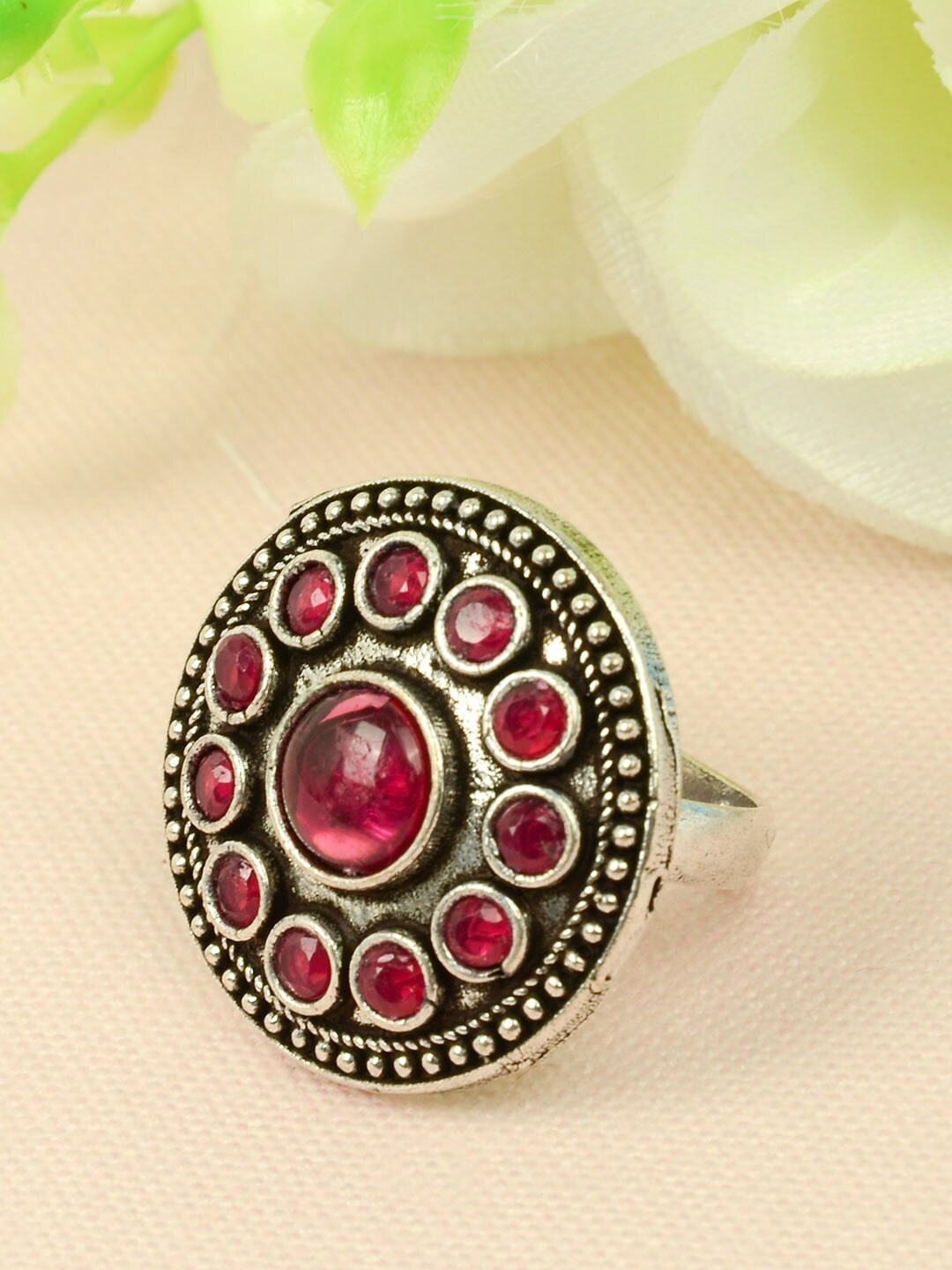 

Urmika Women Silver-Toned & Red Crystal-Studded Circular Charm Oxidized Finger Ring