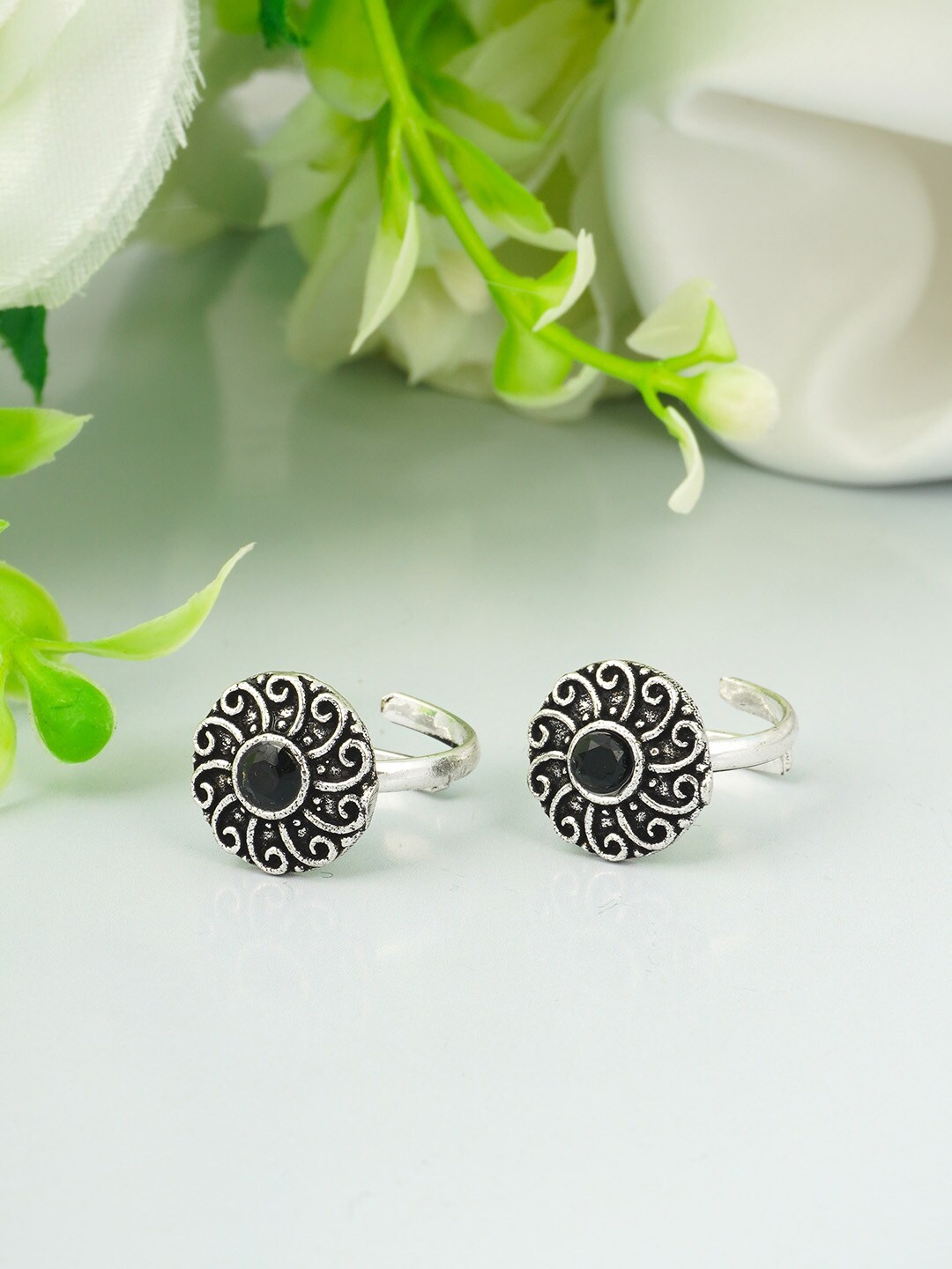 

Urmika Silver Plated & Black Floral Oxidised Toe Rings