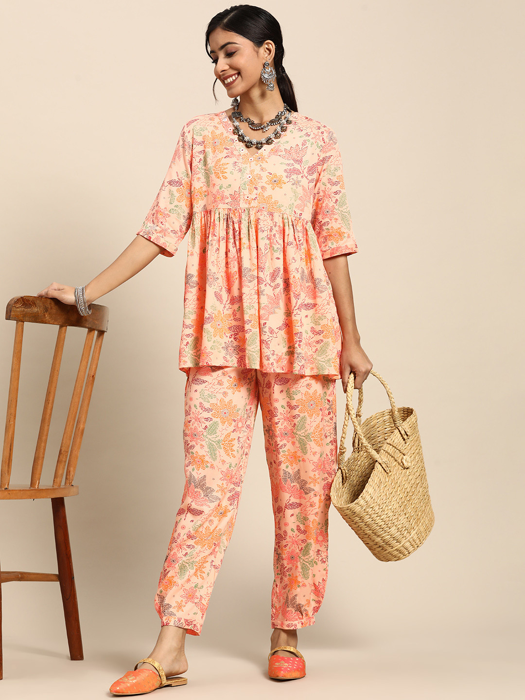 

Sangria Women Peach-Coloured & Green Ethnic Motifs Printed Kurti with Trousers