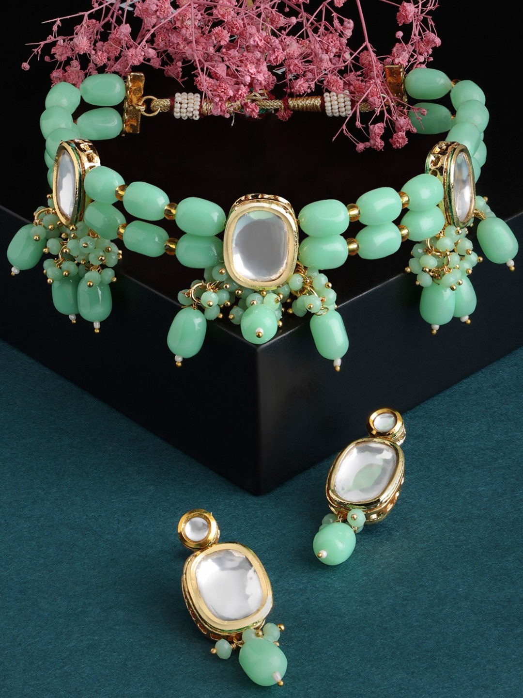 

Zaveri Pearls Gold-Plated White Kundan Studded & Green Beaded Jewellery Set