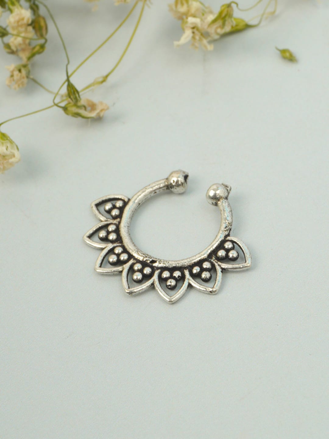 

Urmika Silver-Toned & Black Petal Embellished Oxidized Septum Nosepin
