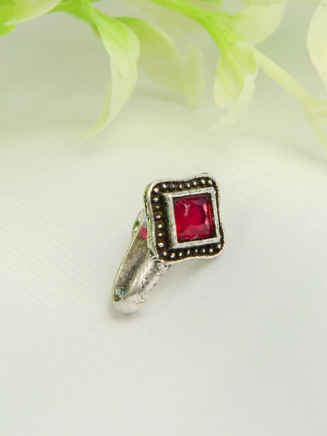 

Urmika Silver-Plated Red Stone-Studded Oxidised Clip-On Nosepin