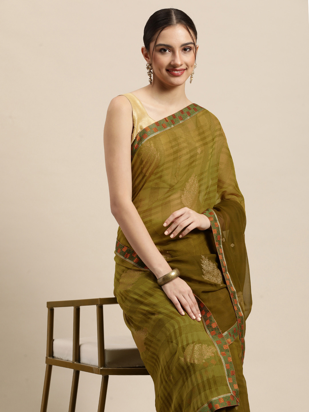 

Triveni Olive Green & Gold Ethnic Motifs Zari Pure Georgette Celebrity Saree