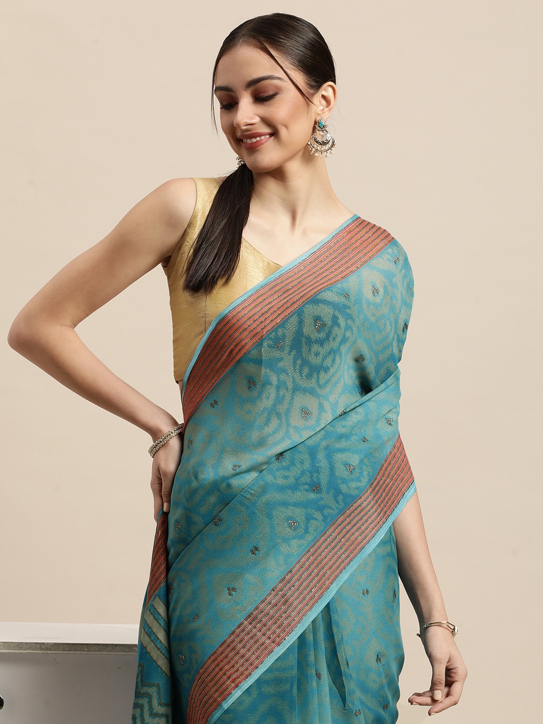 

Triveni Blue & Gold Ethnic Motifs Zari Pure Georgette Celebrity Saree