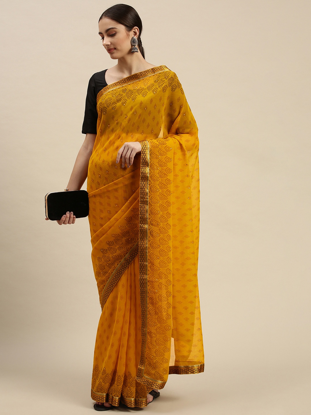 

Triveni Mustard Ethnic Motifs Beads and Stones Pure Chiffon Saree