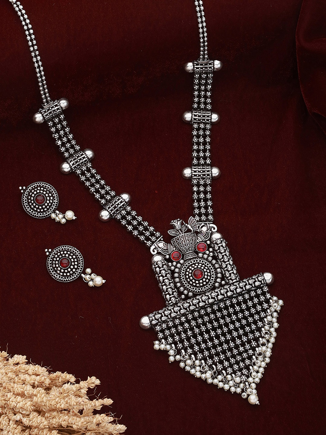 

Saraf RS Jewellery Silver-Toned & Red Stone Studded & Beaded Oxidised Jewellery Set