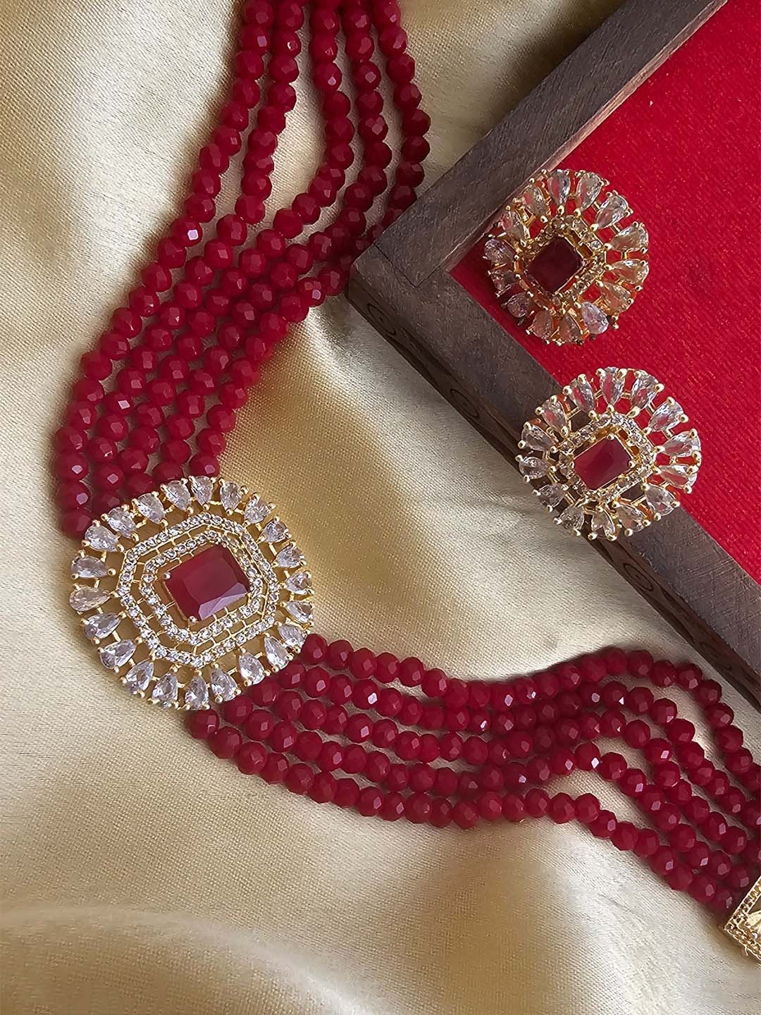 

Binnis Wardrobe Gold-Plated Red & White Kundan Studded & Beaded Jewellery Set