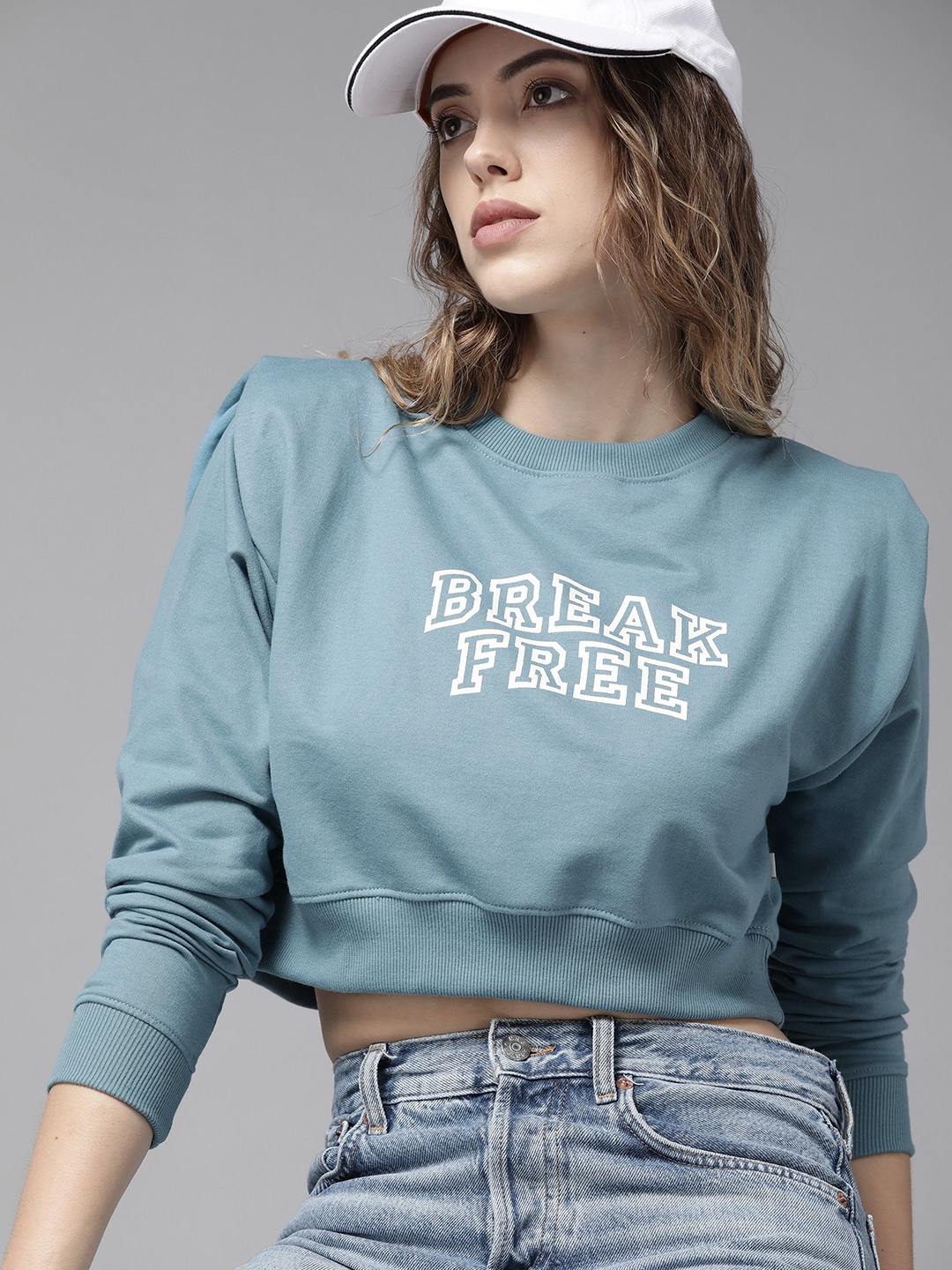 

Roadster Women Blue Printed Shoulder Pad Cropped Sweatshirt