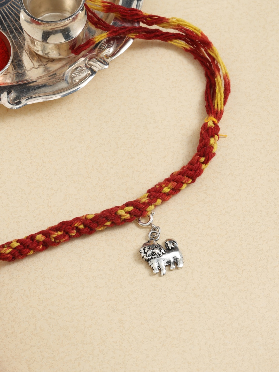 

ADORN by Nikita Ladiwala Unisex Silver-Plated & Red Rakhi