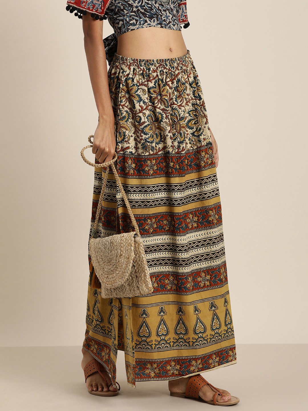 

Taavi Women Beige And Red Kalamkari Printed Flared Maxi Skirt With A Side Slit
