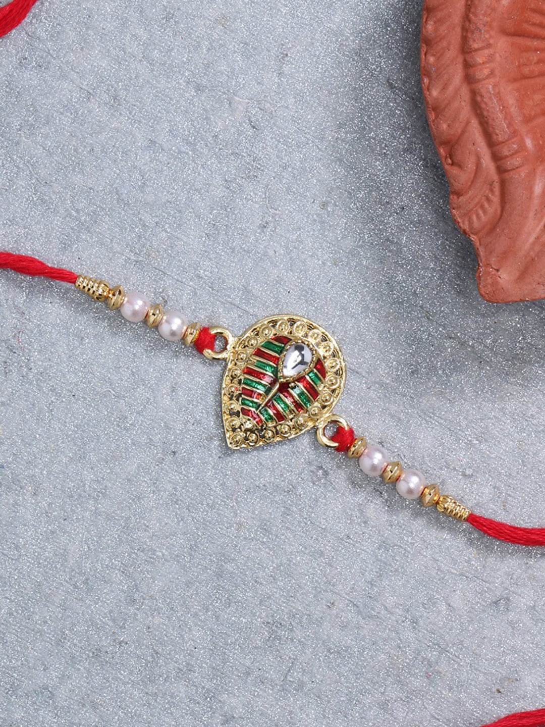 

LIVE EVIL Maroon Gold-Plated Meenakari Rakhi