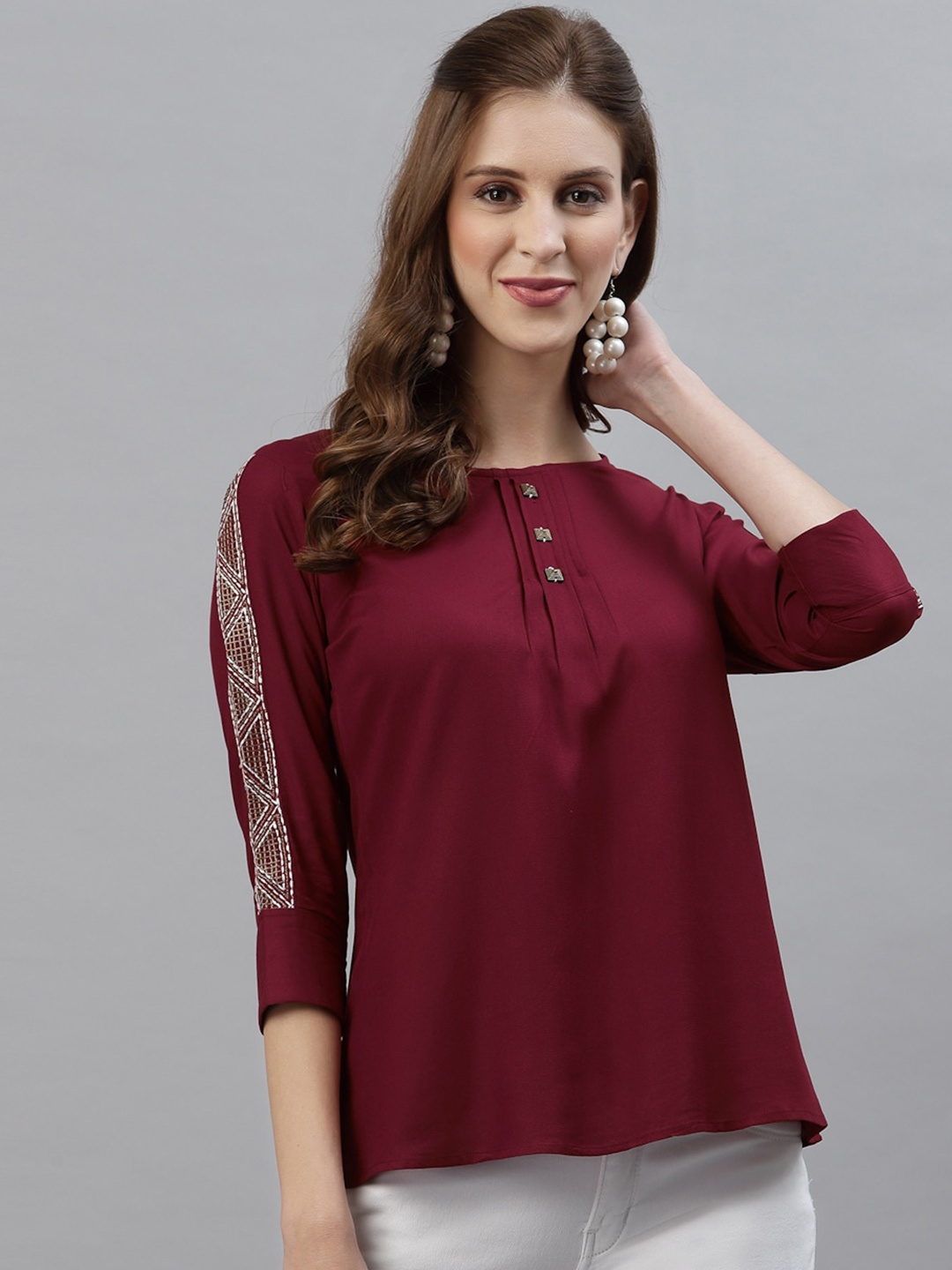 

Selvia Maroon Solid Round Neck Top With Embroidered Detail