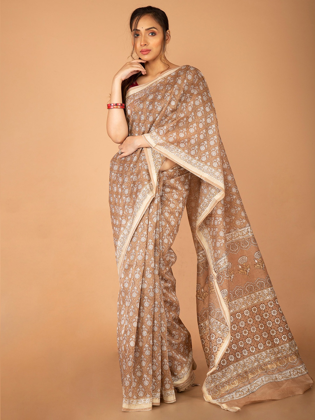 

Unnati Silks Brown & Golden Floral Zari Silk Cotton Chanderi Saree