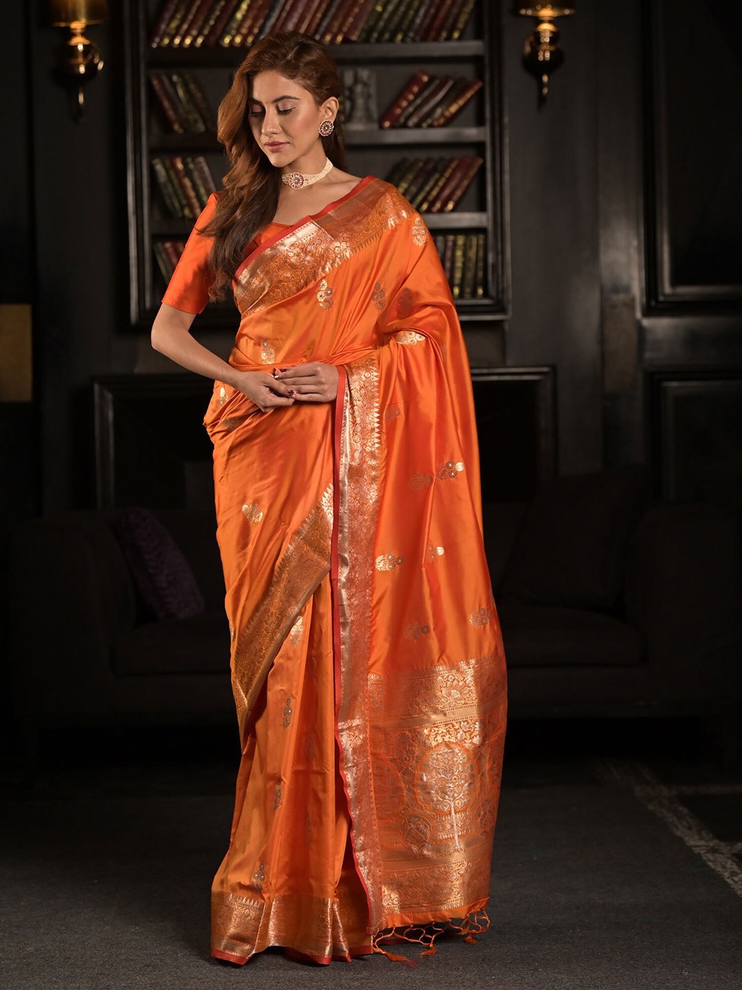 

Exclusiva Orange & Golden Floral Zari Silk Blend Saree