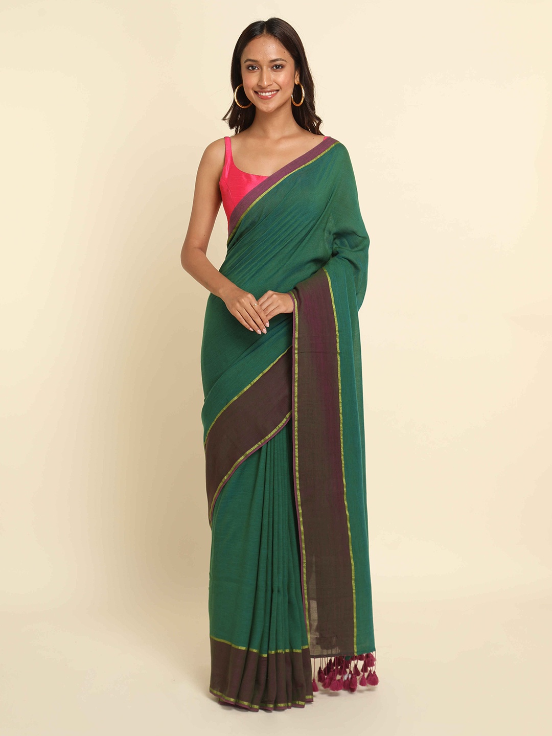 

Suta Green & Purple Solid Cotton Blend Saree