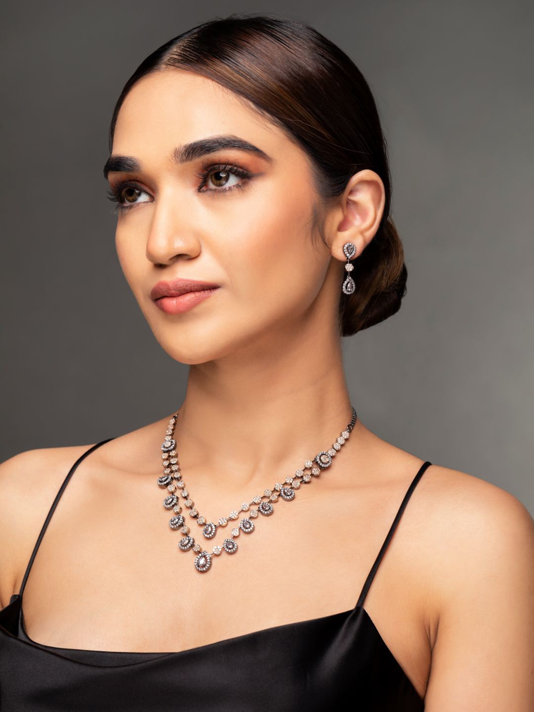 

Priyaasi Women Rose Gold Plated Black AD-Studded & Beaded Dual-Layered Jewellery Set