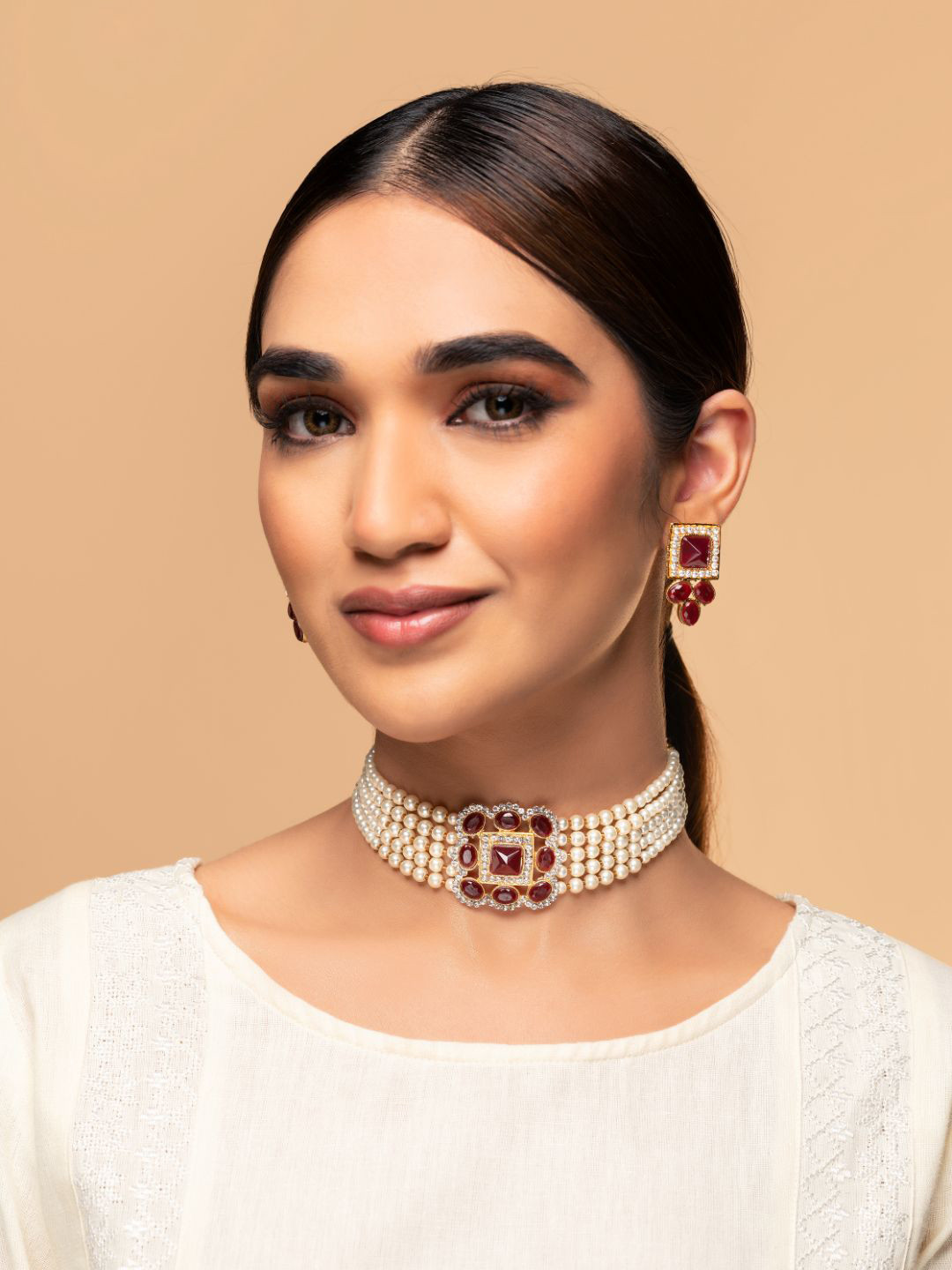 

Priyaasi Women Gold-Plated Maroon Red Block Stone-Studded & White Pearl Beaded Jewellery Set