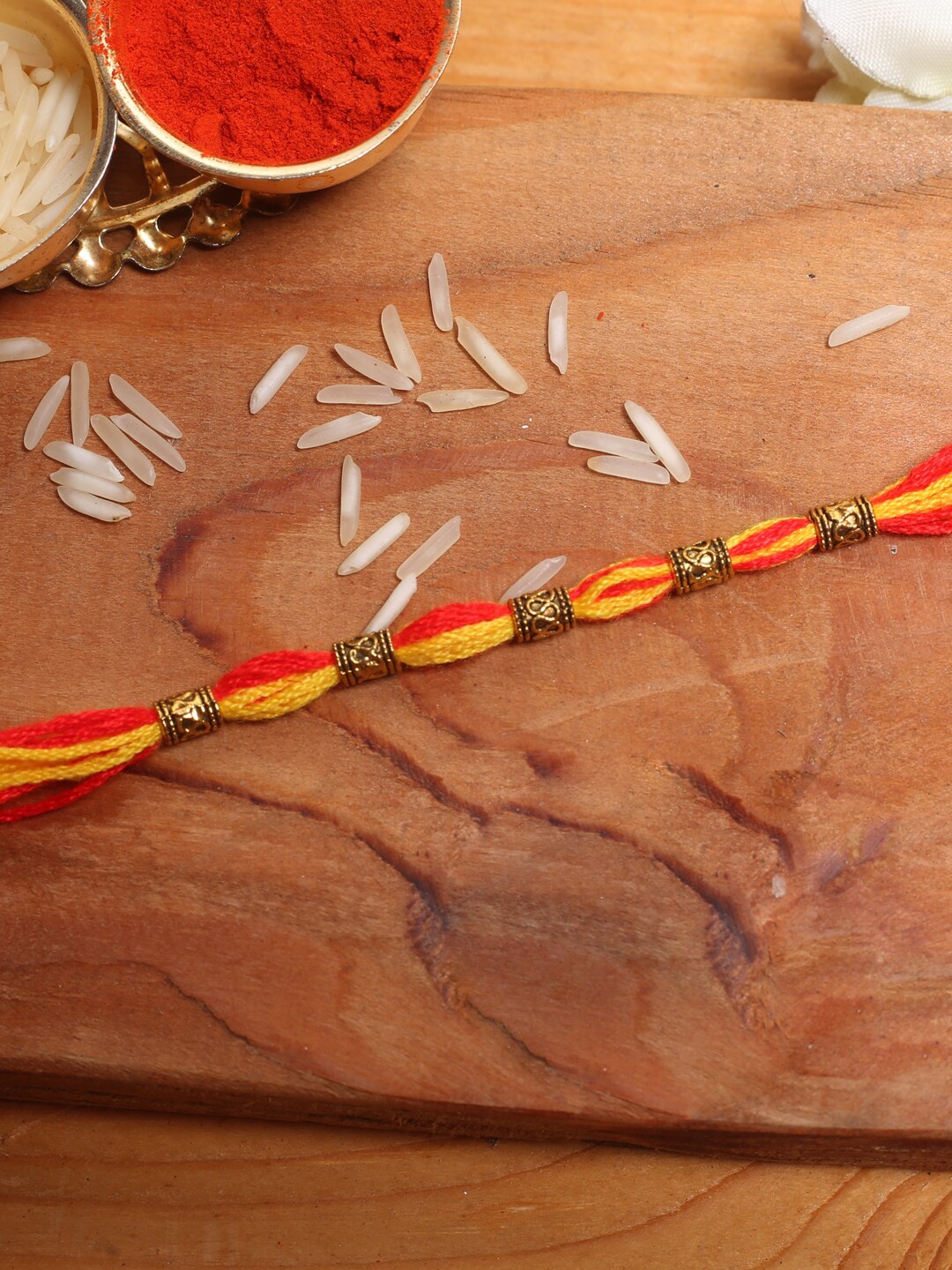 

Aapno Rajasthan Yellow Thread Tie-Up Rakhi