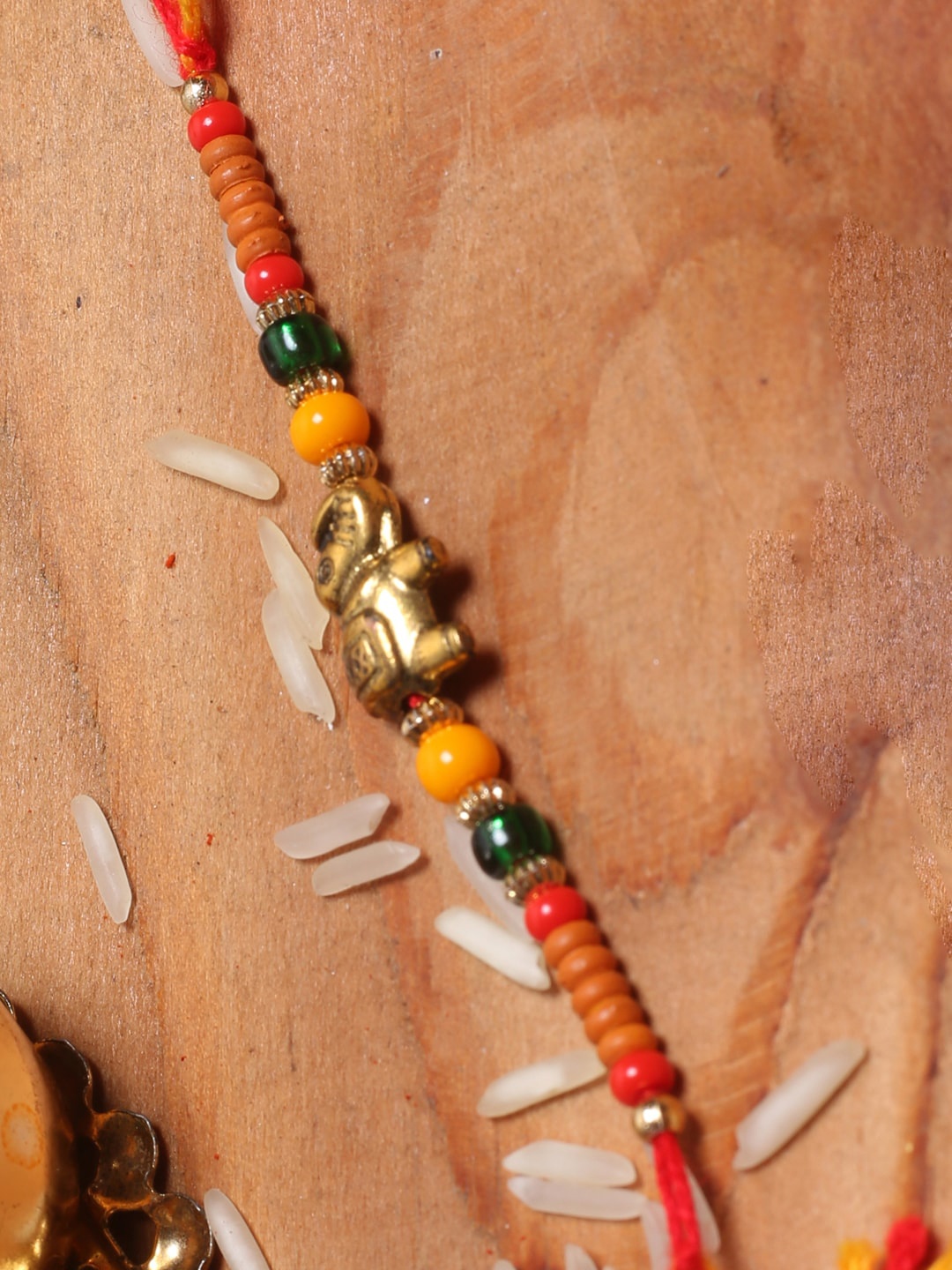 

Aapno Rajasthan Yellow Elephant Motif Beads Rakhi