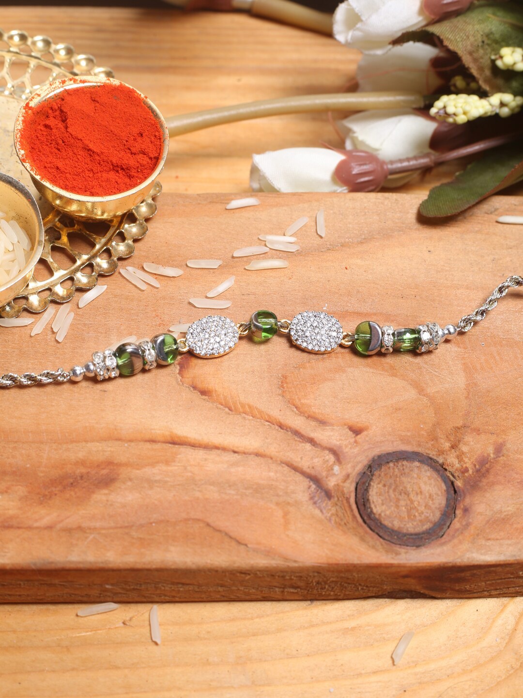 

Aapno Rajasthan Silver-Plated Green Beads and Diamond-Studded Rakhi