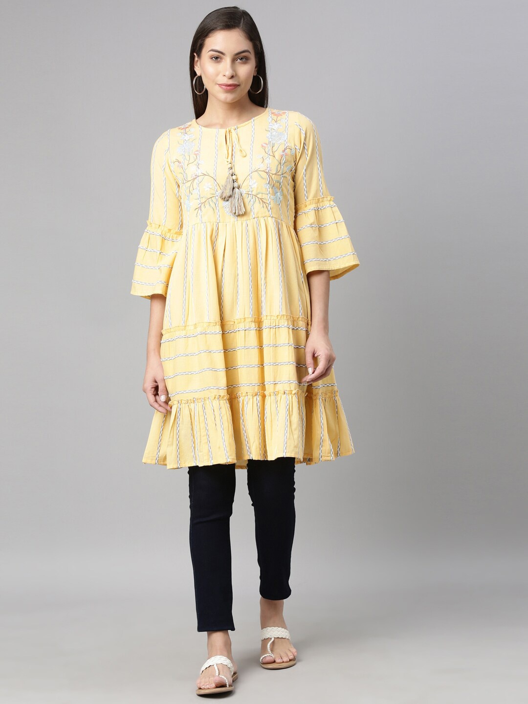 

Neerus Yellow & White Floral Yoke Design Flared Sleeves Tiered Kurti