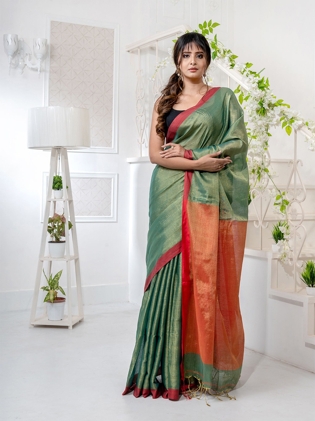 

Charukriti Green & Orange Zari Tissue Saree