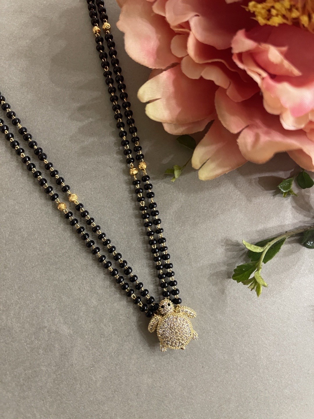 

Digital Dress Room Gold-Plated & White AD-Studded Black Beaded Mangalsutra Set
