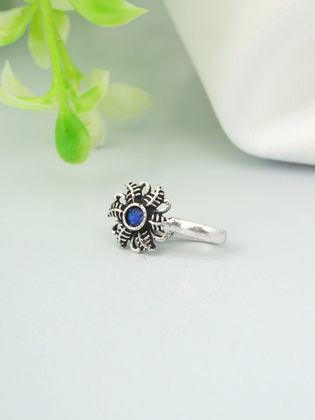 

Urmika Silver-Toned Blue Stone Studded Oxidised Nosepin