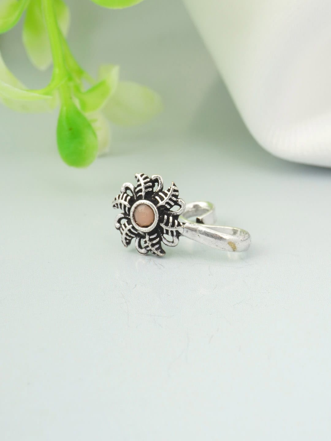 

Urmika Oxidised Silver-Toned Peach coloured Stone Studded Slip-On Nosepin
