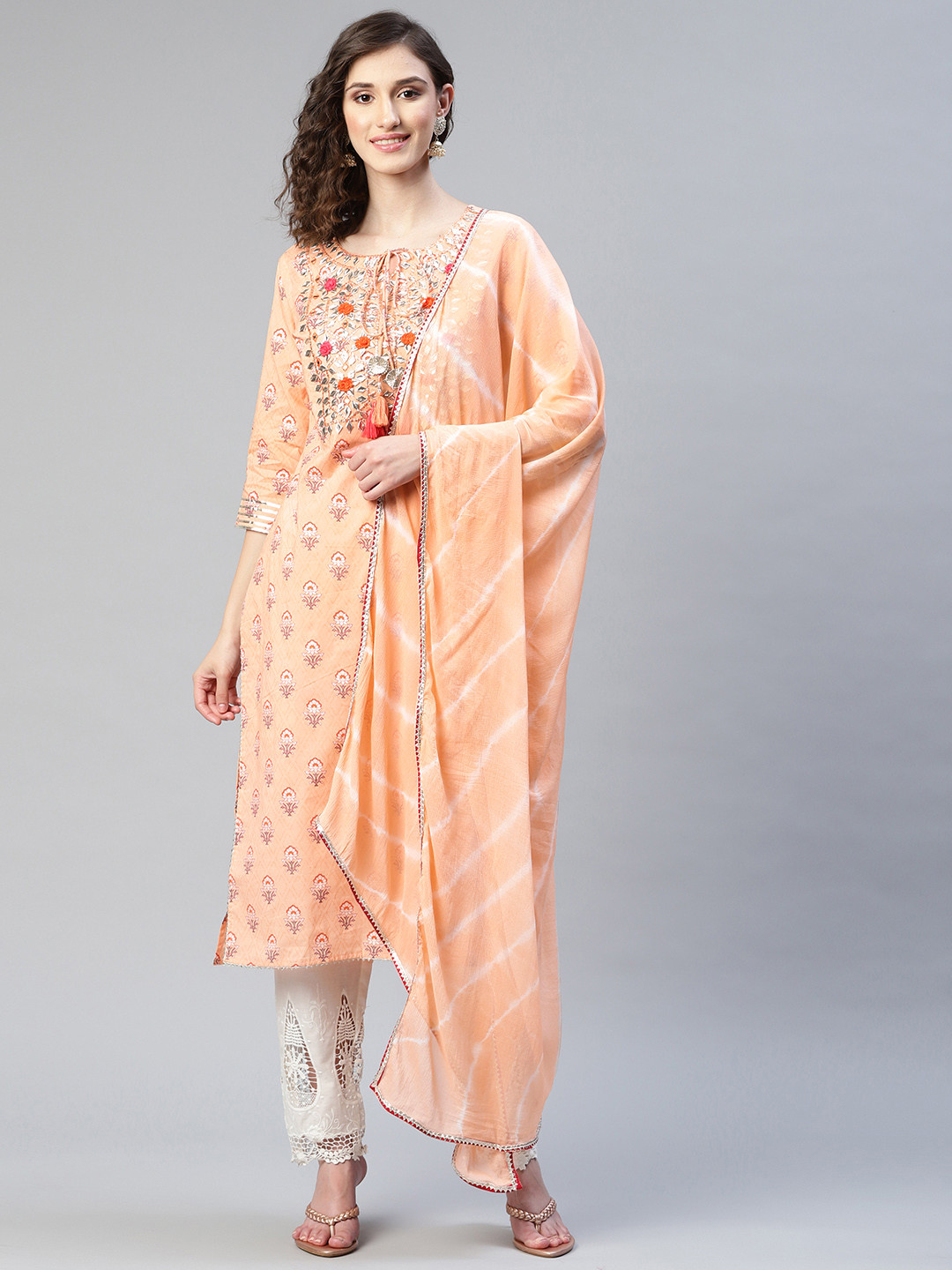 

Readiprint Fashions Women Peach-Coloured Printed Cotton Kurta with Trousers & Dupatta