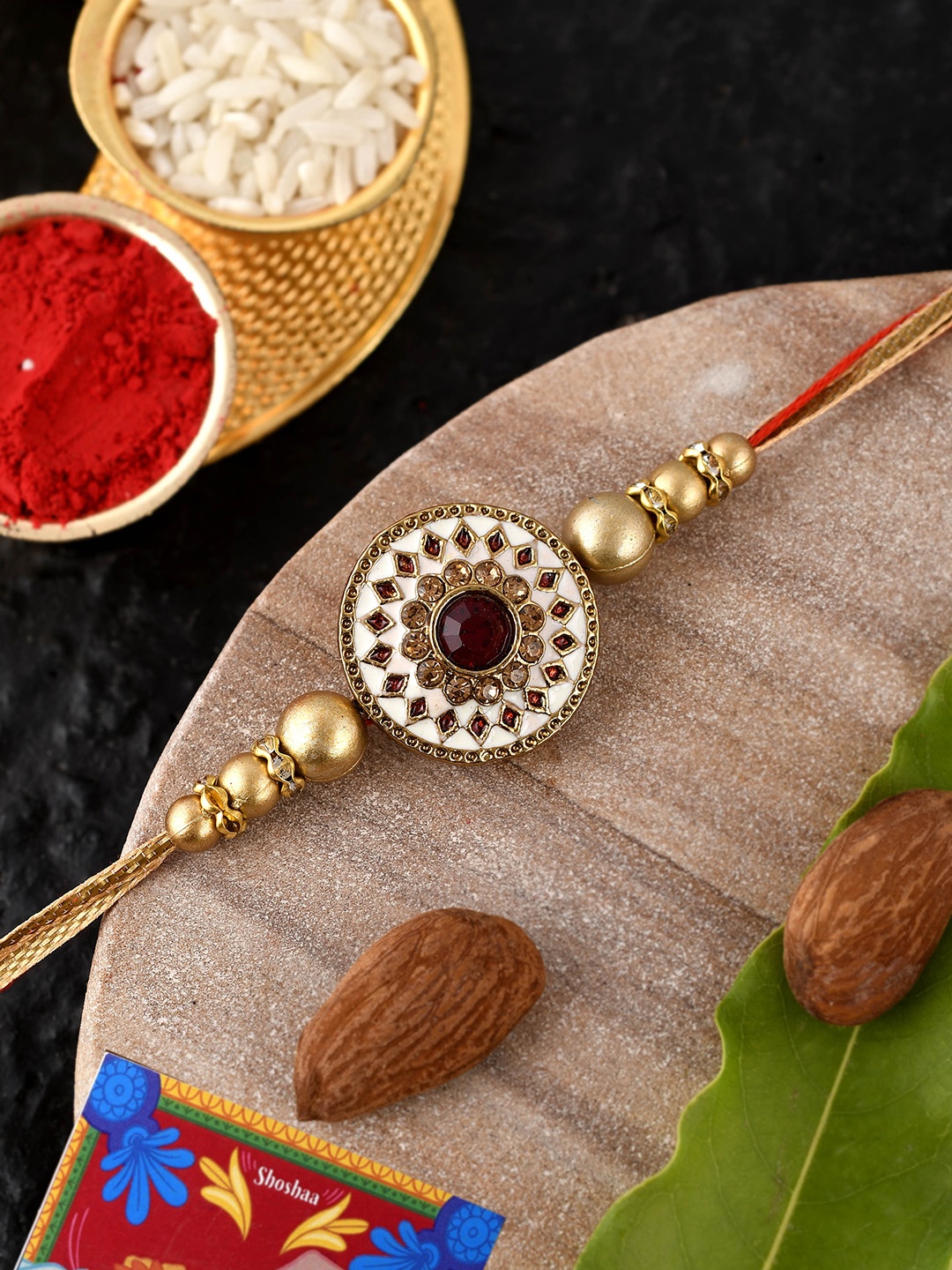 

Shoshaa Gold Toned White & Maroon Meenakari Work & Enamel Single Bhai Rakhi